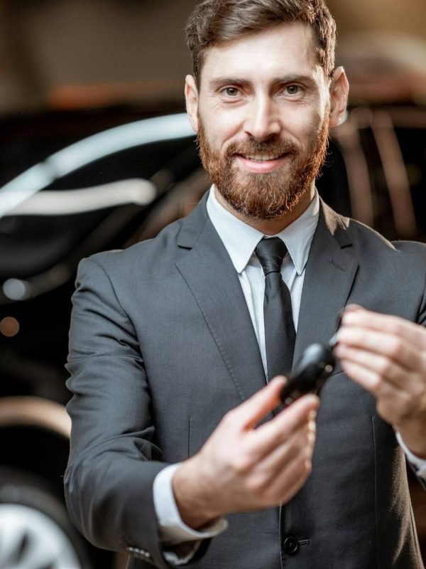 salesman-with-key-at-the-car-dealership.jpg